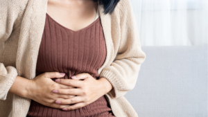 woman feeling bloated touching her stomach
